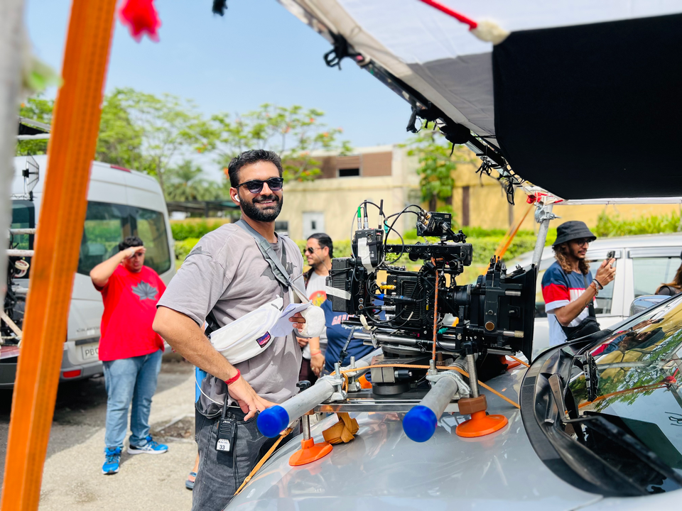 Ravi Prakash working beside a cinema camera on set